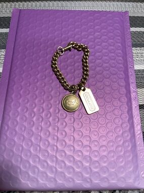 Coach Gold-Tone Link Logo Charms or bracelet.